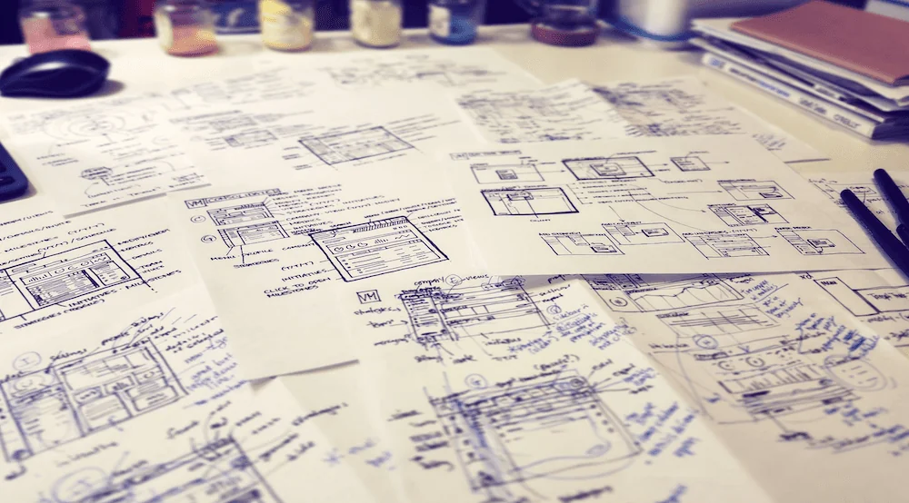 Sheets of sketched wireframes on a table